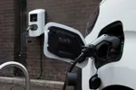 Electric van plugged into charge point