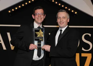 James Taylor, fleet sales director, Vauxhall (left), collects the award from Elliot Scott, fleet director, Thrifty Car & Van Rental