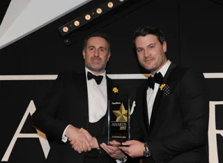 Stuart Thomas, head of fleet services and SME at The AA (left), receives the award from Škoda UK head of fleet Henry Williams