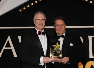 Hyundai national fleet sales manager Paul Williams (left) receives the award from UK transport minister John Hayes CBE