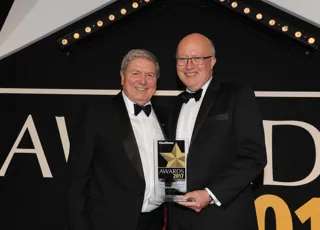 Activa Contracts managing director Ian Hill (left) is handed the award by Jaguar Land Rover fleet and business general manager Jon Wackett