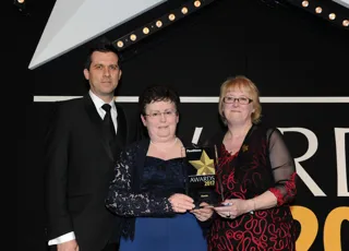 Skanska head of fleet Julie Madoui (centre) and fleet risk and compliance manager Alison Moriarty collect the award from Andrew Brown-Allan, group marketing director, Trak Global Group