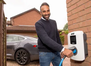 One of the final Electric Nation EV home smart chargers is installed for trial participant Sunny Vara