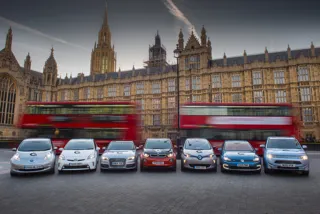row of electric cars outside houses of parliament