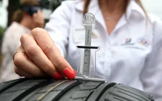 Lady measuring tyre depth