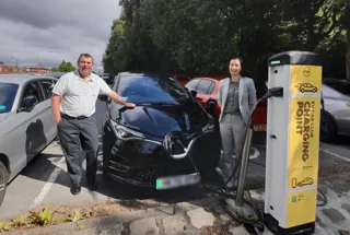 Councillor Alan Quinn and Candice Turner from Enterprise Car Club with the electric hire cars at Fairfax Road, Prestwich