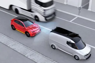 A red car with sensors braking behind a white van