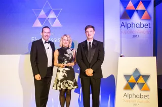 Fleet Assist business development manager Joanna Cooper who collected the Award from Matt Sutherland (left), Alphabet chief operating officer, and host Ed Gamble