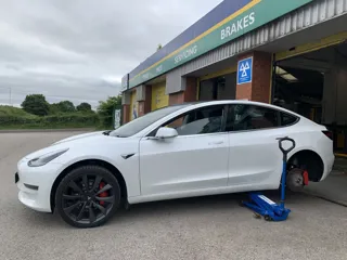 Tesla having tyre changed outside ATS workshop