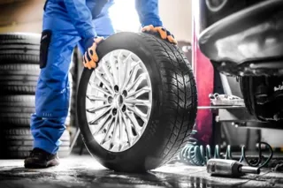 Mechanic with tyre - Image credit: Shutterstock/Krasula