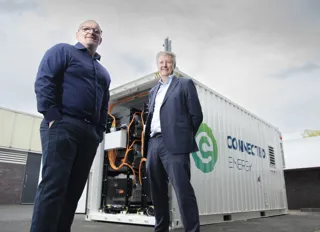 Ian Lilley and Matthew Lumsden in front of E-Stor battery container