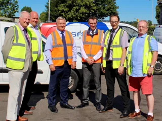 Staff from both councils in front of council vehicles