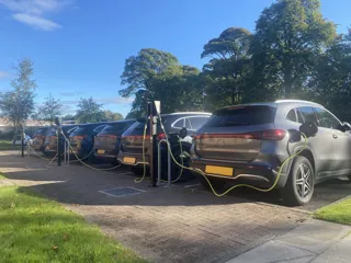 Row of electric company cars being charged