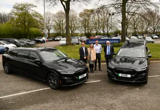 An electric limousine and hearse with Lee Dillow, senior funeral productivity and change manager; Sarah Maynard-Enock, senior procurement manager; Lee Bevan, head of funeral; and Mike Taaffe, funeral logistics and support manager