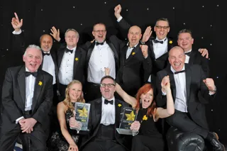 Director of fleet and SME services Stuart Thomas (seated centre) and Kirsty Pendleton, senior marketing manager, Fleet and SME (seated right), celebrate with members of the AA team
