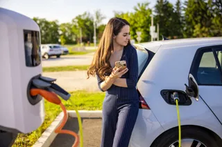 Woman charging an EV