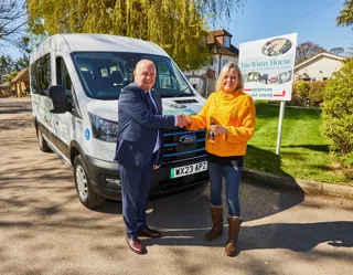 Wayne Toms from PHVC handing keys over to Emma Hampton, manager of The White House