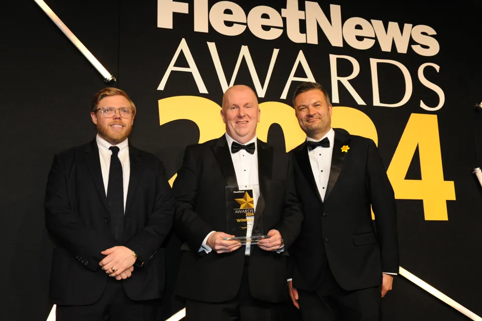 Mark Wilkie - centre -receives the Fleet Dealer of the Year Award 2024 for TrustFord