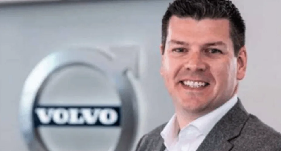 Rob Morris in front of Volvo logo