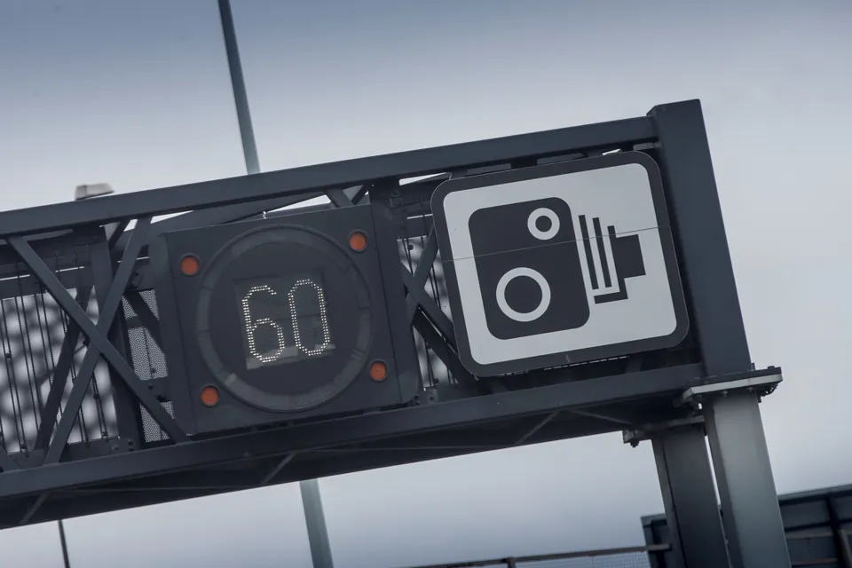 Speed camera sign on motorway gantry